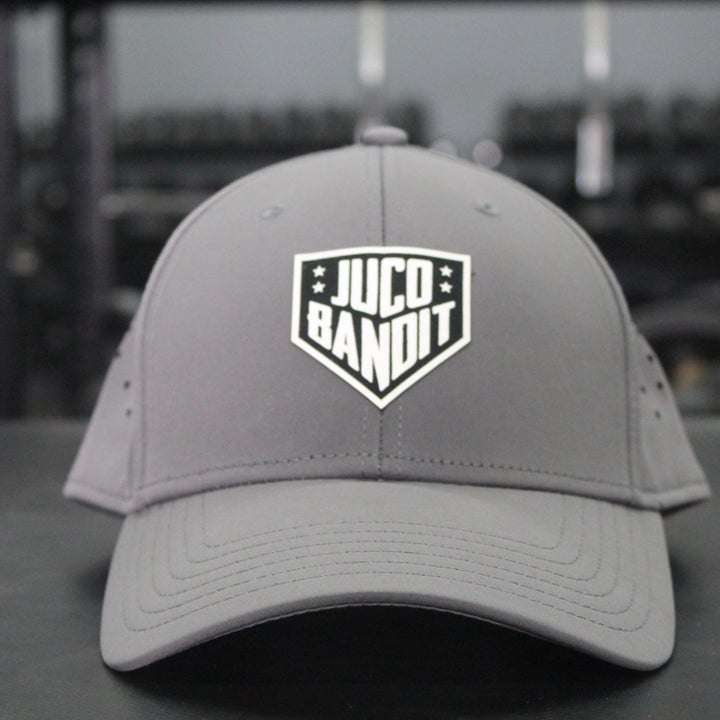 Eric Sim King of Juco Bandit grey performance hat front in gym