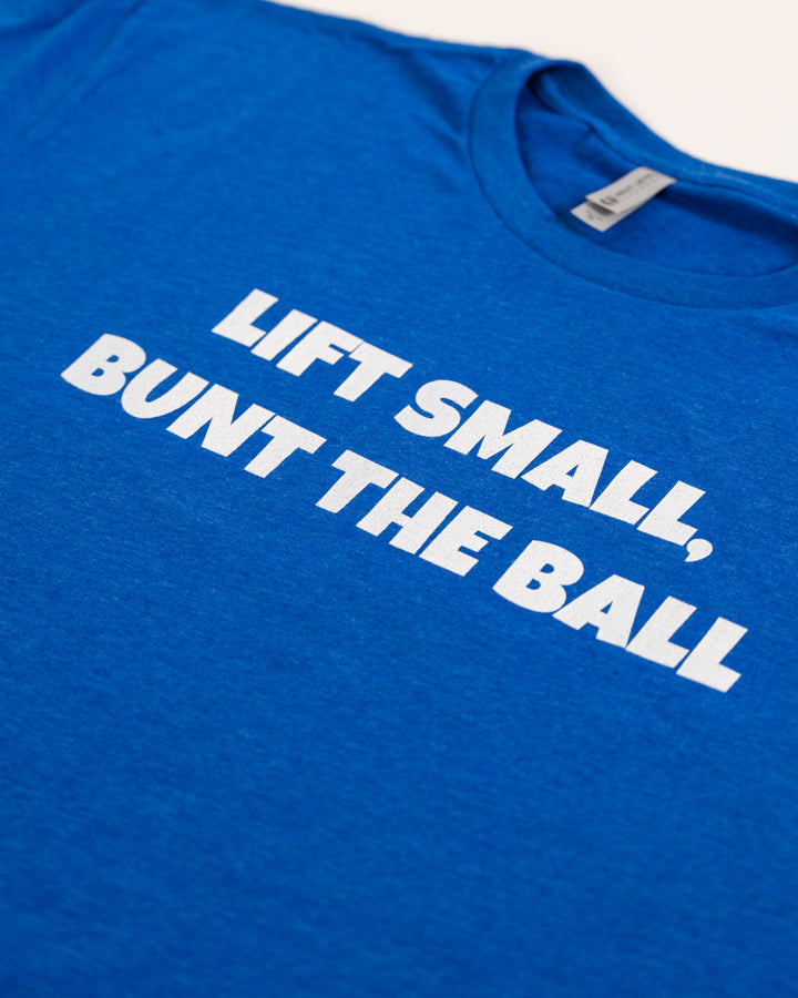 Momentum apparel Lift Small Bunt The Ball Blue Tee print up close angle