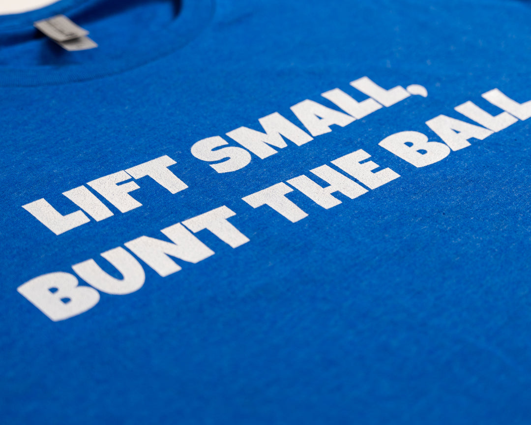 Momentum apparel Lift Small Bunt The Ball Blue Tee print up close