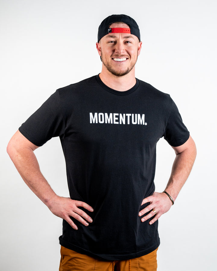 Tosh wearing Momentum Premium Baseball Apparel Black Tee