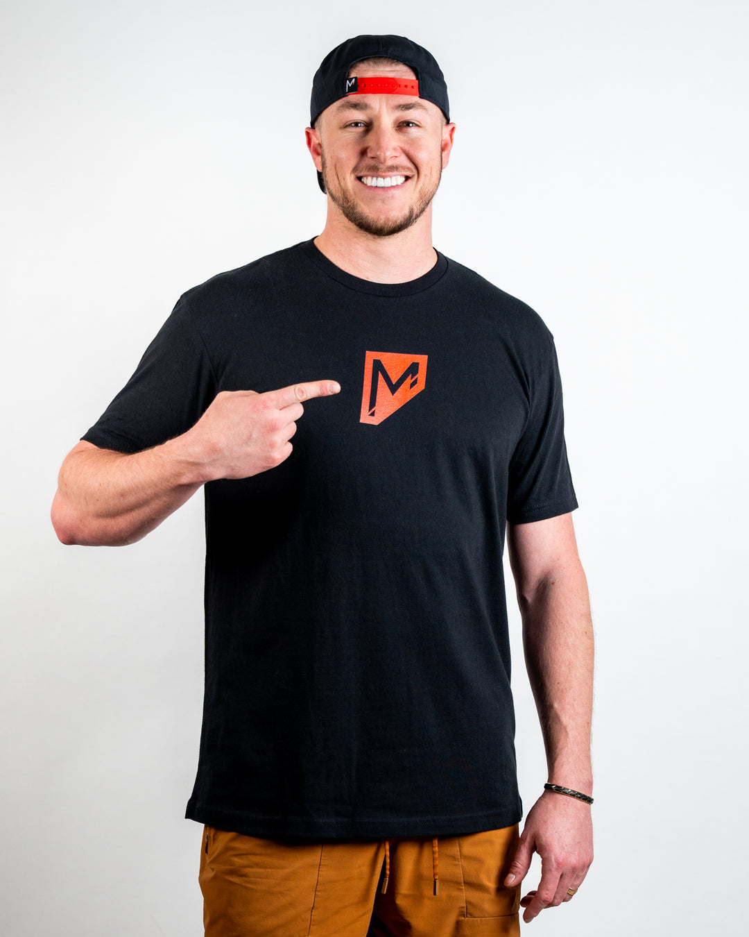 Tosh wearing Momentum Apparel Shield Red Tee