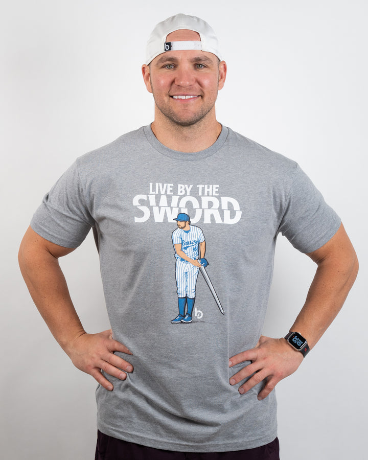 Tim wearing Trevor Bauer Outage Live By The Sword grey tee