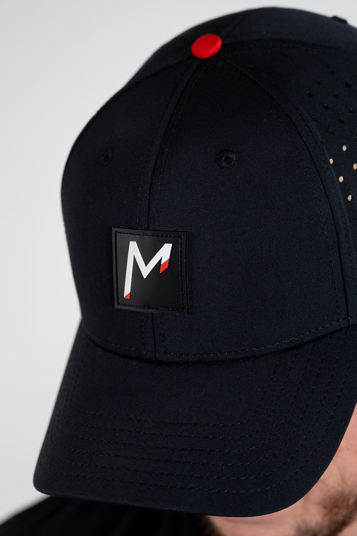 tosh wearing Momentum apparel black performance hat snapback 2